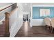 Bright hallway with hardwood floors, white wainscoting, and elegant details leading to the living areas at 115 Cliffview Dr, Garner, NC 27529
