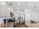 Modern kitchen with stainless steel appliances, granite countertops, white subway tile backsplash, and updated cabinets at 115 Cliffview Dr, Garner, NC 27529