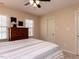Bedroom with neutral walls, ceiling fan, wood dresser and two windows at 11619 John Allen Road Rd, Raleigh, NC 27614