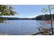 Scenic lake view with trees lining the shore and a clear blue sky, offering a tranquil and picturesque setting at 11619 John Allen Road Rd, Raleigh, NC 27614