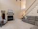 Bright living room featuring a fireplace, staircase, and comfortable seating arrangement at 11619 John Allen Road Rd, Raleigh, NC 27614