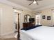 Bright main bedroom featuring a four-poster bed, dresser, and access to the outdoors at 11619 John Allen Road Rd, Raleigh, NC 27614