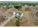 Aerial view of the home showcasing the treed surroundings, long driveway, and detached garage at 1210 Poplar Forest Lane Ln, Pittsboro, NC 27312