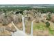 Aerial view of the property featuring a long driveway and a wooded boundary at 1210 Poplar Forest Lane Ln, Pittsboro, NC 27312
