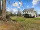 Spacious backyard featuring a swing, mature trees, back deck and screened porch at 1210 Poplar Forest Lane Ln, Pittsboro, NC 27312
