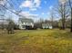 Large backyard featuring a playground, fire pit, detached garage and treed boundary at 1210 Poplar Forest Lane Ln, Pittsboro, NC 27312