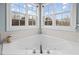 This bathroom has a soaking tub beneath two sunny windows at 1210 Poplar Forest Lane Ln, Pittsboro, NC 27312