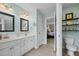 Bright bathroom featuring double vanity, a toilet, and access to a bedroom at 1210 Poplar Forest Lane Ln, Pittsboro, NC 27312