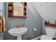 Bathroom with a pedestal sink, toilet, decorative fixtures and a mirror cabinet at 1210 Poplar Forest Lane Ln, Pittsboro, NC 27312