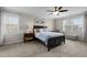 This cozy bedroom features neutral walls, two windows, ceiling fan, and plush carpet at 1210 Poplar Forest Lane Ln, Pittsboro, NC 27312