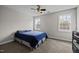 This simple bedroom features two windows, ceiling fan, and neutral colored walls at 1210 Poplar Forest Lane Ln, Pittsboro, NC 27312