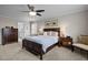 This bedroom offers a ceiling fan, two side tables with lamps, and doorway to bathroom at 1210 Poplar Forest Lane Ln, Pittsboro, NC 27312