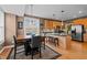 Open dining room features a dining table, kitchen bar with seating, wood floors, and natural lighting at 1210 Poplar Forest Lane Ln, Pittsboro, NC 27312