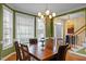 Elegant dining room with a large window, chandelier, and hardwood floors at 1210 Poplar Forest Lane Ln, Pittsboro, NC 27312