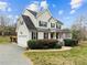 Charming two-story home with a front porch, attached garage, and a well-maintained lawn at 1210 Poplar Forest Lane Ln, Pittsboro, NC 27312