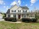 Front exterior of home with covered porch, traditional windows, manicured landscaping at 1210 Poplar Forest Lane Ln, Pittsboro, NC 27312