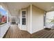 Covered front porch featuring white columns, a wood floor, and ample space for relaxing at 1210 Poplar Forest Lane Ln, Pittsboro, NC 27312