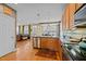 Open-concept kitchen features stainless steel appliances, wood cabinets, hardwood floors and backyard views at 1210 Poplar Forest Lane Ln, Pittsboro, NC 27312