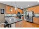 Well-lit kitchen features a breakfast bar, stainless steel appliances, and wooden cabinetry with a mosaic tile backsplash at 1210 Poplar Forest Lane Ln, Pittsboro, NC 27312