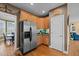 Spacious kitchen features stainless steel appliances, wood floors and cabinetry, and backyard access at 1210 Poplar Forest Lane Ln, Pittsboro, NC 27312