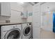 Convenient laundry room with washer, dryer, counter space, and access to bathroom at 1210 Poplar Forest Lane Ln, Pittsboro, NC 27312