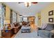 Cozy living room with hardwood floors, a leather sofa, and an open-concept view into the dining area at 1210 Poplar Forest Lane Ln, Pittsboro, NC 27312