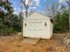 Exterior view of a storage shed featuring double doors, sconces, and ramp at 1210 Poplar Forest Lane Ln, Pittsboro, NC 27312