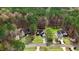 Aerial view of three homes surrounded by mature trees and well-manicured lawns showing neighborhood layout at 129 Bennett Pl, Clayton, NC 27527