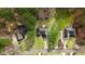 Aerial view of three well-maintained homes each with a driveway and mature trees surrounded by a lush lawn at 129 Bennett Pl, Clayton, NC 27527