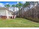 View of home's backyard featuring a lush lawn, wooded perimeter and part of the deck at 129 Bennett Pl, Clayton, NC 27527