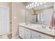 Bright bathroom boasts double sinks with white cabinets, large mirror and shower at 129 Bennett Pl, Clayton, NC 27527