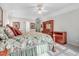 Relaxing bedroom featuring a floral quilt, hardwood furniture and natural light at 129 Bennett Pl, Clayton, NC 27527