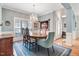 Bright dining area showcasing a wooden table set with view of the front door at 129 Bennett Pl, Clayton, NC 27527