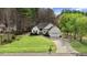 Charming single-story home with manicured lawn, black shutters, and a two-car garage at 129 Bennett Pl, Clayton, NC 27527