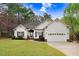 Charming single-story home with a manicured lawn, two-car garage, and lovely curb appeal at 129 Bennett Pl, Clayton, NC 27527
