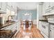 Bright kitchen with granite counters, stainless appliances, and an adjacent dining area at 129 Bennett Pl, Clayton, NC 27527