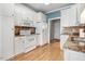 Well-maintained kitchen featuring white appliances, granite counters, and ample cabinets at 129 Bennett Pl, Clayton, NC 27527