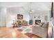 Comfortable living room featuring a fireplace, neutral furniture, and ample light at 129 Bennett Pl, Clayton, NC 27527