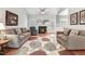 Inviting living room with comfortable couches, fireplace, and vaulted ceiling at 129 Bennett Pl, Clayton, NC 27527