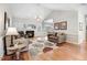 Open living space showcasing hardwood floors, fireplace, and bright, natural light at 129 Bennett Pl, Clayton, NC 27527