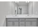 Well-lit bathroom with double sinks and a large mirror reflecting ample natural light at 1434 Rosepine Dr, Cary, NC 27519