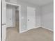 Minimalist bedroom with several white doors, carpet flooring, and neutral walls offers a blank canvas at 1434 Rosepine Dr, Cary, NC 27519
