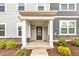 Inviting front entryway with a classic covered porch, stone accents, and decorative landscaping enhances curb appeal at 1434 Rosepine Dr, Cary, NC 27519