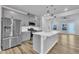 Modern kitchen featuring stainless steel appliances, gray cabinets, a center island, and seamless open-concept design at 1434 Rosepine Dr, Cary, NC 27519