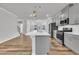Modern kitchen with stainless appliances, gas range, island, and gray cabinetry at 1434 Rosepine Dr, Cary, NC 27519