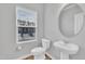 A clean powder room with a pedestal sink and a window offering natural light at 1434 Rosepine Dr, Cary, NC 27519
