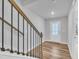 Staircase with wood handrail and iron balusters leading to a door with glass panes at 1434 Rosepine Dr, Cary, NC 27519