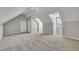 Finished attic space with a door, window and neutral walls and carpet, ready to be used as a bonus room or bedroom at 147 Tralee Dr, Smithfield, NC 27577