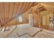 The unfinished attic's frame shows a partially insulated space with a window, ready for customization into a functional living area at 147 Tralee Dr, Smithfield, NC 27577