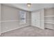 Bedroom featuring carpet, a ceiling fan, a window, and double-door closet at 147 Tralee Dr, Smithfield, NC 27577